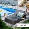 A man relaxing by a pool next to a double lounger, with a woman walking in the background. Produktbild-Vorschau