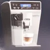 A DeLonghi Autentica Cappuccino coffee machine is shown in a studio setting against a dark background. Voir les images du produit