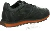 A side view of a green sneaker with an orange sole against a white background. Voir les images du produit