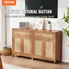 A living room scene featuring a rattan sideboard with decorative items and a large TV screen in the background. Anteprima dell’immagine prodotto