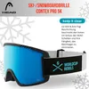 A pair of blue ski goggles with a black and white strap, presented with marketing text and snowflakes. Anteprima dell’immagine prodotto