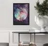 A framed picture hangs on a wall above a console table with books and a decorative vase. Podgląd zdjęcia produktu