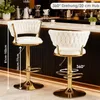 Two white velvet bar stools with gold accents are shown in a bar or kitchen setting. Produktbild-Vorschau