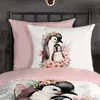 A close-up view of a bed with a duvet cover and pillow featuring a watercolor illustration of penguins and flowers. Produktbild-Vorschau