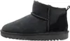 A side view of a black ankle boot.