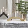 A festive table setting with a Christmas tree and candle holders. Podgląd zdjęcia produktu