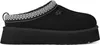 A black UGG mule shoe with a platform sole and decorative trim. Voir les images du produit