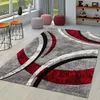 A modern living room with a geometric rug, side tables, and poufs. Produktbild-Vorschau