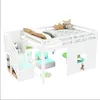 A white loft bed with stairs, a small chair, and a table underneath, decorated with stuffed animals and toys. Voir les images du produit