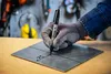 A gloved hand is marking a metal plate with a Sharpie marker. Anteprima dell’immagine prodotto