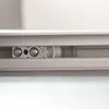 A close-up view of a sliding door mechanism, showing screws and a roller. Produktbild-Vorschau