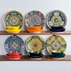A set of decorative ceramic plates and bowls arranged on shelves. Produktbild-Vorschau