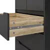 A close-up view of an open drawer in a black dresser, showing the wooden interior and metal drawer slides. Podgląd zdjęcia produktu