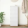 A white chest of drawers with five drawers is shown in a room with a plant and a coat rack. Náhľad obrázku produktu