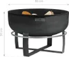 A black metal fire pit on a stand, with wood inside. Produktbild-Vorschau