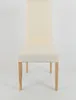 A front view of a cream-colored dining chair with natural wood legs against a white background. Voir les images du produit