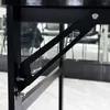 A close-up view of the black metal frame and support structure of a desk. Náhled obrázku produktu