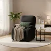 A dark gray recliner chair with a tan blanket and green pillow sits on a round cream rug in a living room. Anteprima dell’immagine prodotto