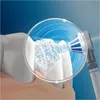 A close-up view of a tooth being cleaned by a water jet from a dental cleaning device. Náhled obrázku produktu