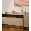 A close-up view of a wooden TV cabinet with decorative items on top. Produktbild-Vorschau