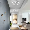 A modern hallway with two ceiling lights, a framed picture on the wall, and a chair near a counter. Produktbild-Vorschau