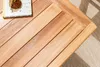 A close-up view of a wooden table with a book on it. Produktbild-Vorschau