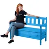 A woman sits on a blue wooden garden bench with storage. Anteprima dell’immagine prodotto