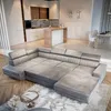 A spacious, modern living room and kitchen area with a large sectional sofa in the foreground. Produktbild-Vorschau