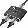 A black bi-directional DisplayPort switch with two DisplayPort cables plugged in. Produktbild-Vorschau