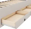 A close-up view of a bed frame with open drawers, showing the interior wood and exterior fabric. Náhled obrázku produktu