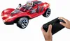 A red remote-controlled toy race car with a driver and a remote control held by a child. Podgląd zdjęcia produktu