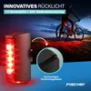 A cyclist is riding a bike at dusk, with a rear bike light illuminating the ground around it. Náhľad obrázku produktu