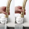 A split image showing a gold kitchen faucet with water flowing from it in two different spray patterns. Podgląd zdjęcia produktu