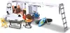 A toy camper van set with accessories laid out around it, including a person, grill, table, chairs, bicycle, and surfboard. Voir les images du produit