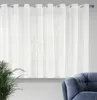 A white sheer curtain hangs across a window, with a potted plant and a blue armchair visible in the foreground. Anteprima dell’immagine prodotto