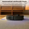 A robot vacuum cleaner with a mopping attachment on a rug, with wooden furniture in the background. Náhľad obrázku produktu