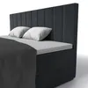 A close-up view of a bed with a dark gray headboard and matching bed frame. Náhled obrázku produktu