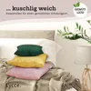 Three corduroy cushion covers are stacked on a bed with a blanket. Produktbild-Vorschau