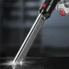 A close-up shot of the nozzle of a cordless vacuum cleaner, with a light illuminating the surface it is cleaning. Produktbild-Vorschau