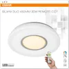 A white ceiling light with a remote control held by a hand, presented on a white background with graphic elements. Produktbild-Vorschau