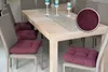 A dining table with chairs and seat cushions. Produktbild-Vorschau