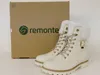 A pair of white Remonte boots are displayed next to their original packaging. Produktbild-Vorschau