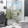 A modern bathroom with a corner shower featuring a beach scene, a toilet, and a vanity. Produktbild-Vorschau