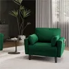A green armchair is placed in a modern living room setting, next to a small side table and a large potted plant. Produktbild-Vorschau