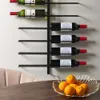 A wall-mounted wine rack holding several bottles of wine, with a bowl of oranges in the foreground. Náhled obrázku produktu