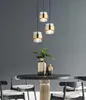 A dining table with chairs and pendant lights. Produktbild-Vorschau