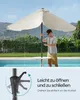A man is operating a patio umbrella next to a swimming pool. Produktbild-Vorschau