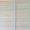 A close-up, full-frame shot of a bamboo roller blind made of many thin bamboo sticks held together by white string. Produktbild-Vorschau