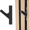 A black hook is shown next to wooden paneling, with one hook attached to the paneling. Produktbild-Vorschau