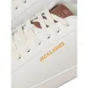A close-up view of the top part of a white sneaker. Voir les images du produit